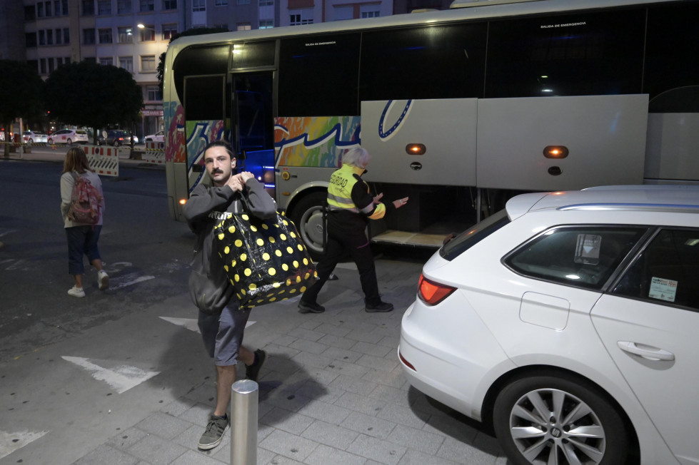 Pasajeros llegan en bus a la estación de tren