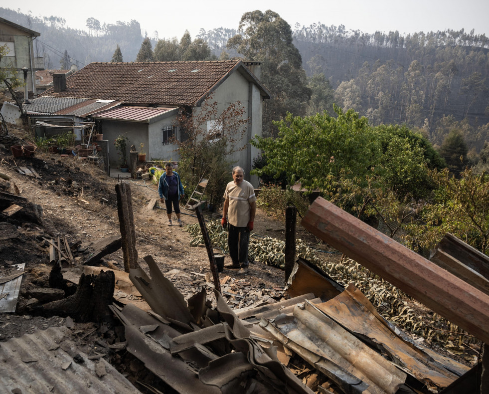 Gondomar (Portugal), 19/09/2024.- Maria Santos (L) and Delfim Moreira (R) stand next to one of their workshops destroyed by the fires that hit Covelo in Gondomar, Portugal, 19 September 2024. At least