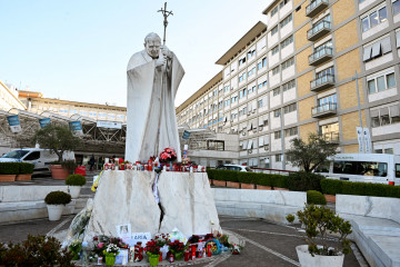 ROME (Italy), 27/02/2025.- Drawings, candles, and messages for the healing of Pope Francis sit at the statue of John Paul II outside Agostino Gemelli Hospital where he remains hospitalized, in Rome, I